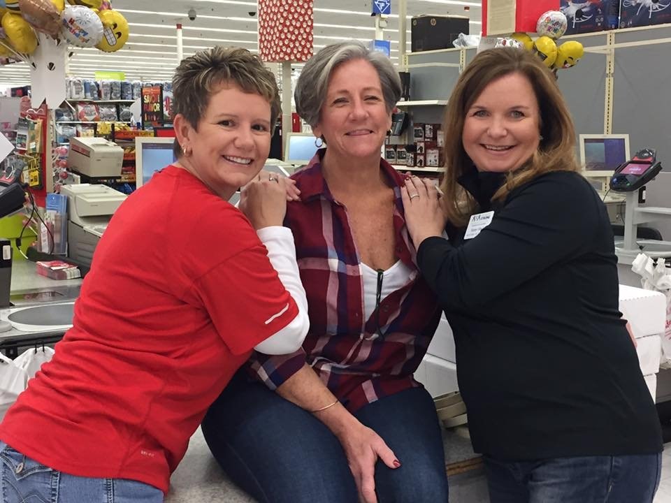 Three women smiling in grocery store