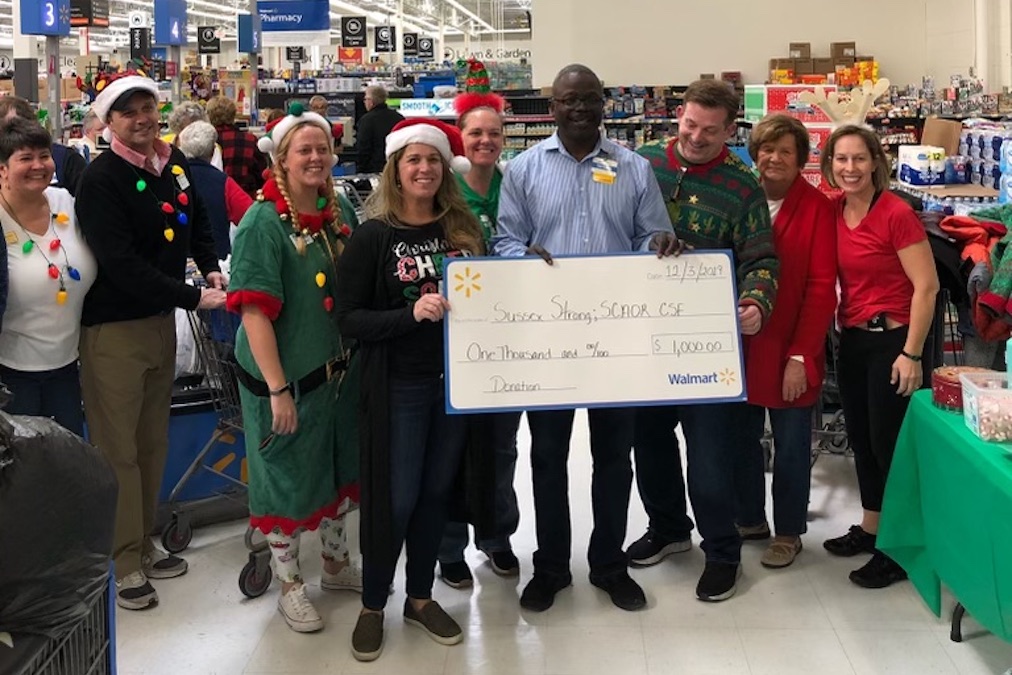 Women holding a check for $500